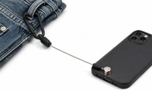 Phone cord attaching to lanyard from phone to jeans